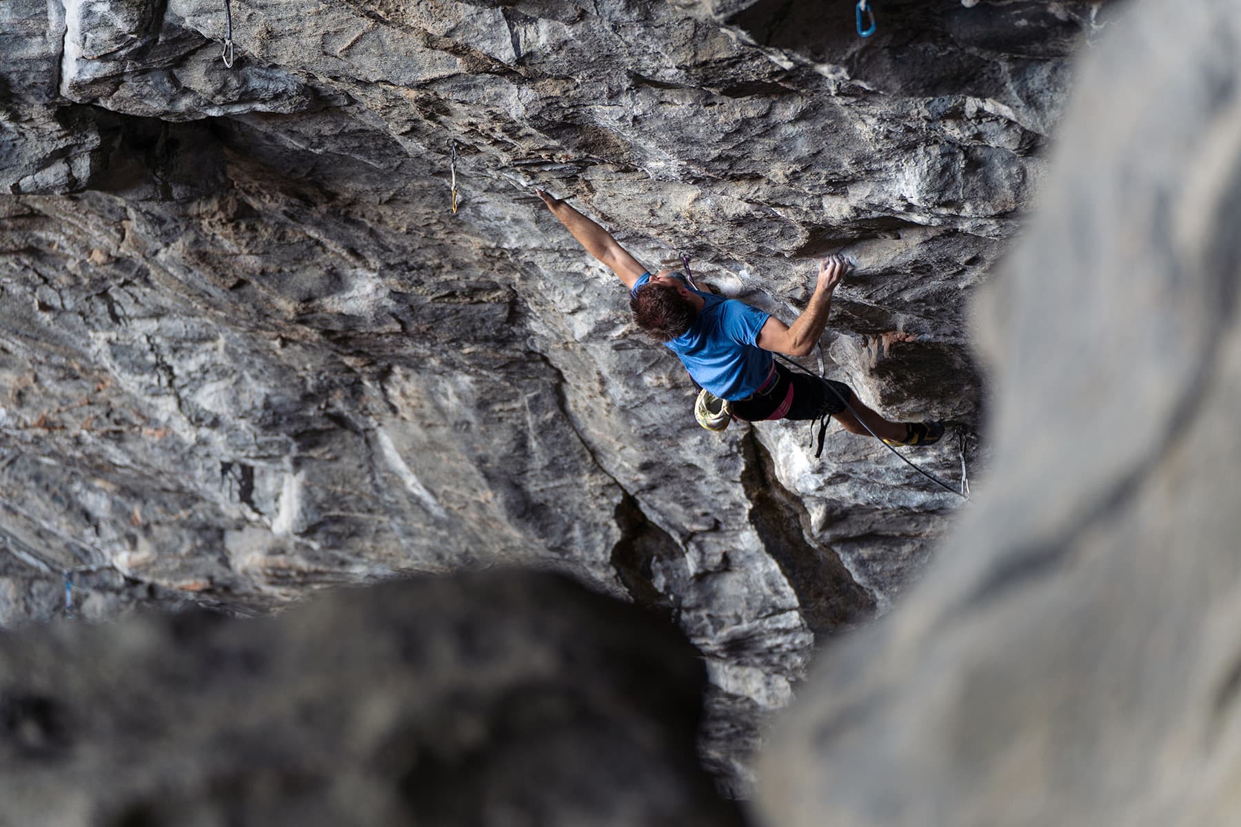 A climber on a steep granite overhang at Flatanger, Norway.